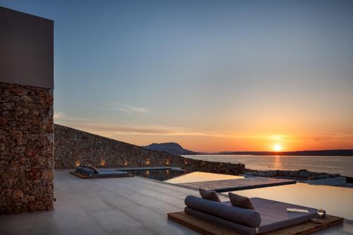 a sunset view from a villa with a swimming pool at Dionysos Boutique Villa FirePit Heated Pool & Sauna in Kókkinon Khoríon