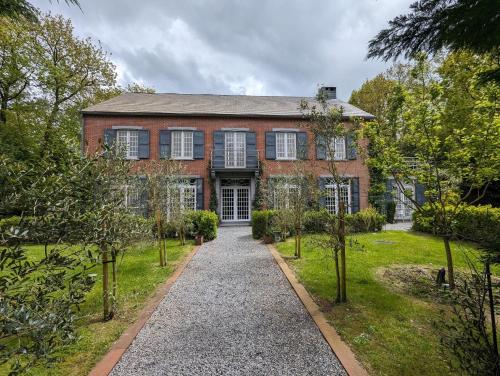 a brick house with a walkway in front of it at Just for sleep in Liège