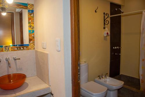 a bathroom with a sink and a toilet and a sink at La Paleta del Pintor Hosteria in Maimará