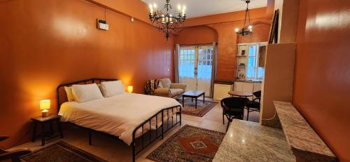 a bedroom with a bed and a living room at La Pelisserie, Chambres d'Hotes in Saint-Antonin-Noble-Val