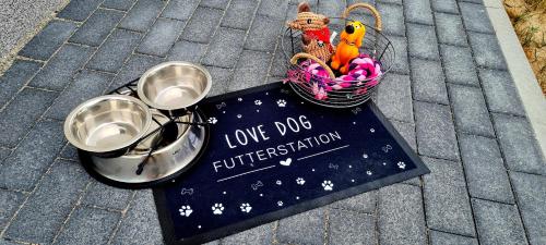 a sign for a love dog fundraiser with a basket of toys at Boddenblick 9 a in Fuhlendorf
