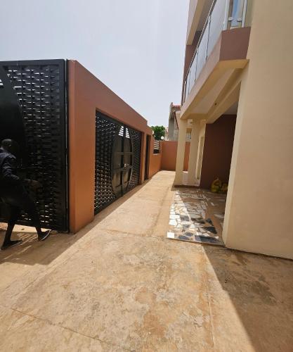 a hallway of a building with a black gate at Safim Suites in Plaque