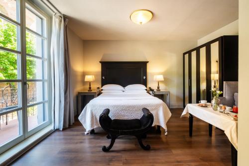 a bedroom with a bed and a large window at Hotel Vannucci in Città della Pieve