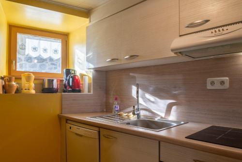 a kitchen with a sink and a counter top at Gîte Gîtes de France 6/7 personnes à Baboyères in Nasbinals