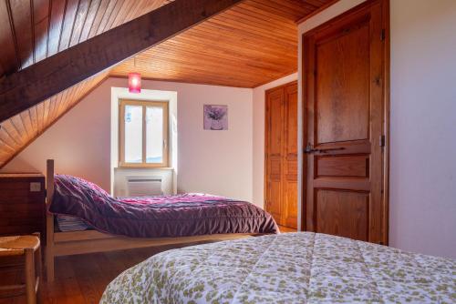 a bedroom with two beds in a attic at Gîte Gîtes de France 6/7 personnes à Baboyères in Nasbinals