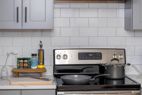 a kitchen with a stove with a pot on it at CityScape in Chelsea