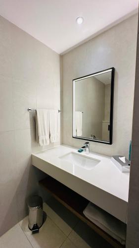 a bathroom with a white sink and a mirror at Hilton Garden Inn Casablanca Sud in Casablanca