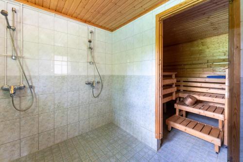 a bathroom with a sauna with a shower at Myllytupa in Merikaarto