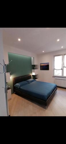 a bedroom with a large bed with a green headboard at Casa Edera in Monterosso al Mare