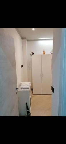a white room with a bed and a cabinet at Casa Edera in Monterosso al Mare