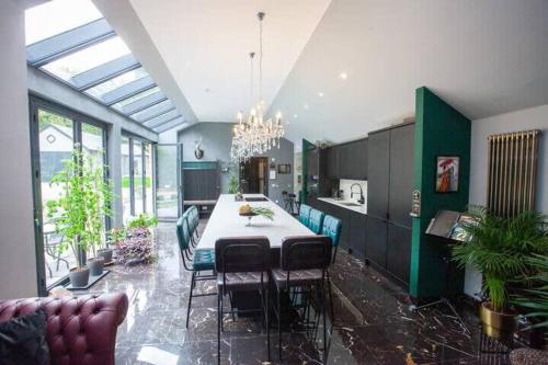 a kitchen with a table and chairs in a room at The Ultimate Luss Retreat in Luss