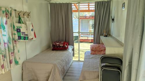 a bedroom with a bed and a mirror and a window at La Campigna, Neuquen in Plottier