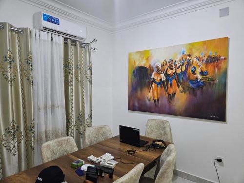 a room with a table and a painting on the wall at Safim Suites in Plaque