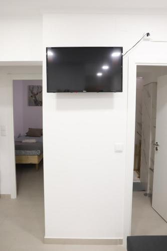 a flat screen tv on a white wall in a room at Oriente DNA Studios V in Lisbon