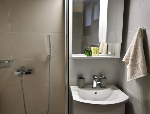 a bathroom with a sink and a shower at Garden House in Corfu in Corfu Town
