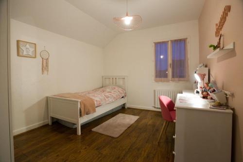 une chambre avec un lit et un bureau dans l'établissement Maison familiale au calme proche de Paris, à Franconville