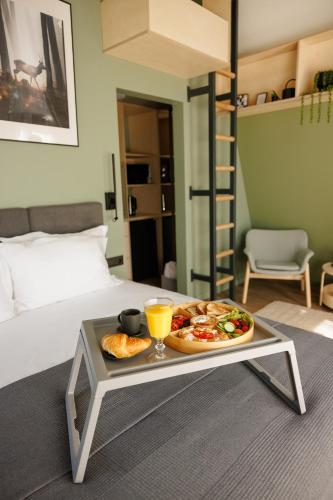 a tray of food on a table in a bedroom at Reconnect Glamping Stulpicani in Stulpicani