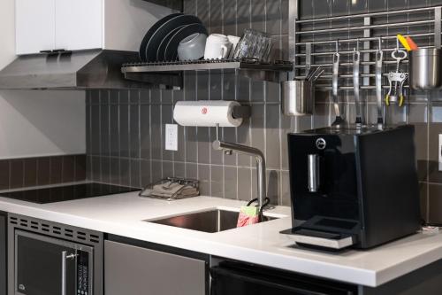 a kitchen with a sink and a microwave at Silverbow Inn in Juneau