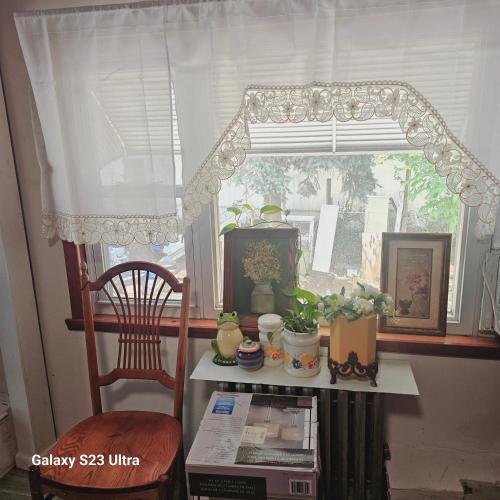 a window with a table and a chair in a room at King Bed with Private Bathroom Divine Villa Harper in Irvington