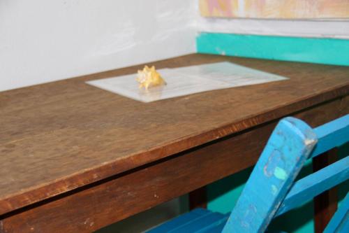a wooden table with a blue chair next to a desk at Casa Samay in Cozumel