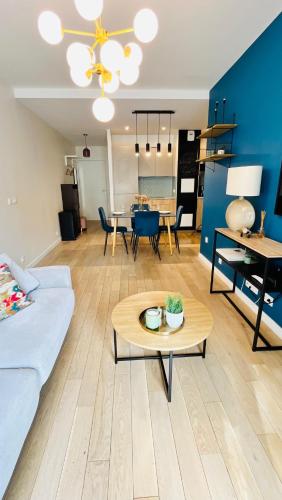 un salon avec un canapé et une table dans l'établissement Riviera Suite - Spacieux T3 - 5 min du métro- Paris centre à 10min, à Asnières-sur-Seine