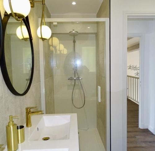 La salle de bains est pourvue d'une douche et d'un lavabo blanc. dans l'établissement Superbe vue mer et Estérel, Villa Neuve pour 8-10 Personnes, Clim, Piscine, à Saint-Raphaël