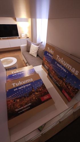 two boxes sitting on a table in a living room at Center Apartments Tukums in Tukums