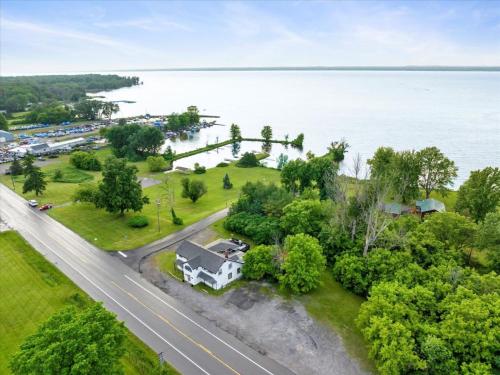 an aerial view of a house next to the water at Whitewater The Genoa on Oneida Lake Sleeps 8 in Canastota