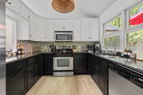 a kitchen with white cabinets and a stove top oven at The High Life in New Buffalo