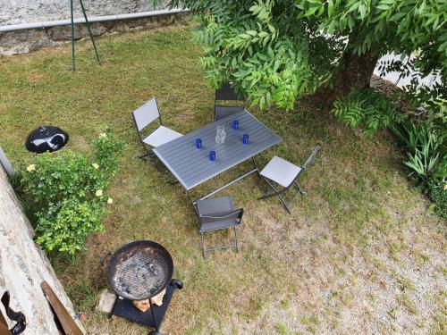 an overhead view of a table and chairs and a grill at Gîte Gîtes de France 4/6 personnes à la Vialatte in Saint-Symphorien