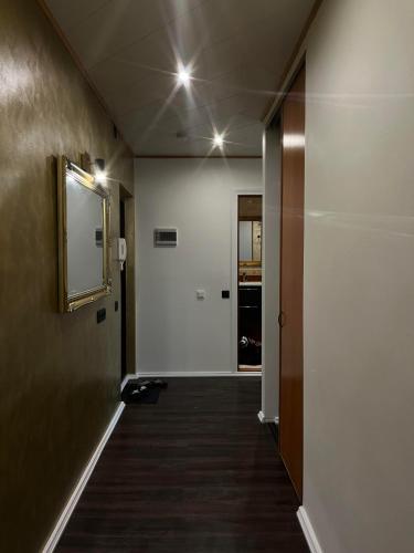 a hallway of an office with a mirror and a door at Kitse 26 Apartment- FREE PARKING in Pärnu
