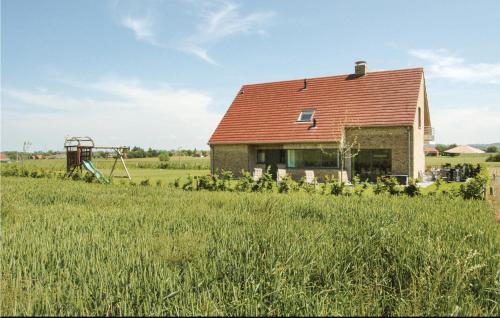 a house in a field with a swing at Lieke in Poperinge