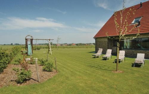 a yard with a playground with chairs and a building at Lieke in Poperinge