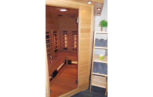 a walk in closet with a glass door at Lieke in Poperinge