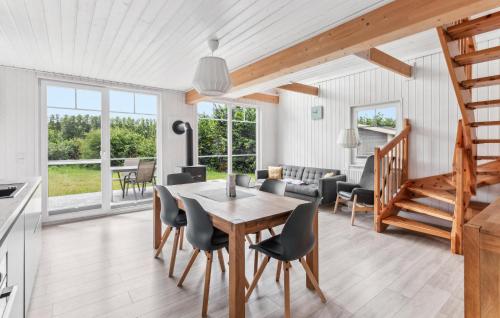 a kitchen and living room with a table and chairs at Two-Bedroom Holiday Home In Zerpenschleuse in Zerpenschleuse