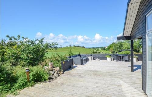 a wooden walkway next to a building with a field at Gorgeous Home In Knebel With Sauna in Knebel