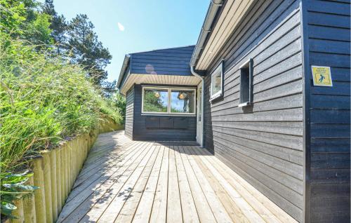 a wooden walkway leading to the door of a house at Gorgeous Home In Knebel With Sauna in Knebel