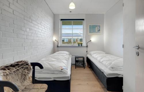 a room with two beds and a window at Stunning Home In Havndal With Wifi in Havndal