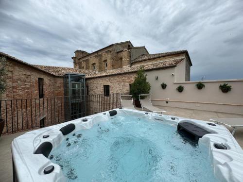 a large swimming pool in front of a building at Dimora Santa Chiara in Ripatransone