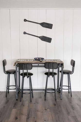 a table with four chairs and a sculpture on the wall at The Mooring in Hammondsport