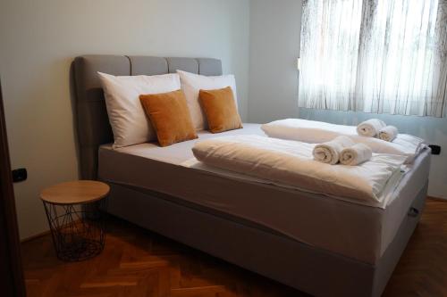 a bed with towels on it with a window at Apartments Villa Marta in Opatija