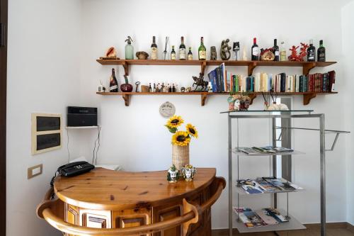 a room with a table and shelves with books at Villa Giulia Tonnara di Bonagia in Valderice