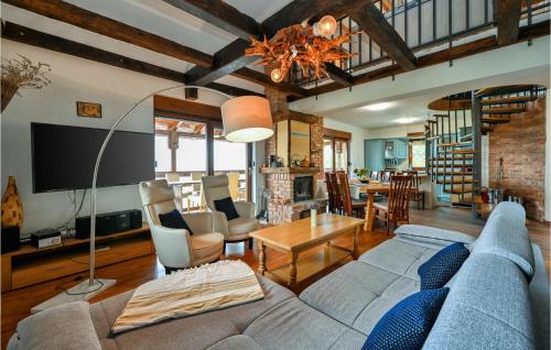 a living room with a blue couch and a table at Nice Home In Zelezna Gora With Sauna in Grabrovnik