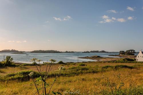 - une vue sur une étendue d'eau avec une maison dans l'établissement Les Bambous de Bugueles, à Penvénan