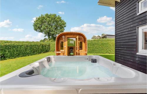 a hot tub in the backyard of a house at Lovely Home In Haderslev With Sauna in Store Anslet