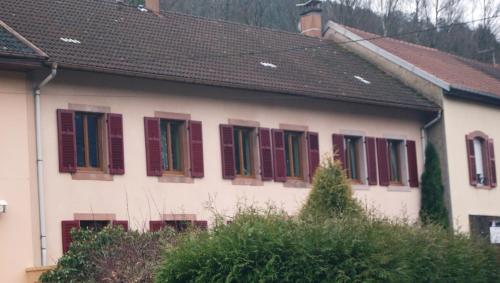 a white house with red shutters on it at Gîte "À Moussey vous" in Moussey