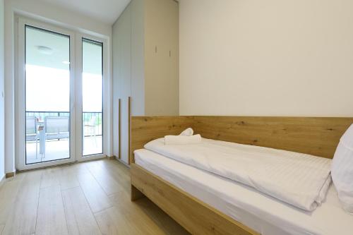 a bedroom with a large bed and a large window at Alpine Haven in Bovec