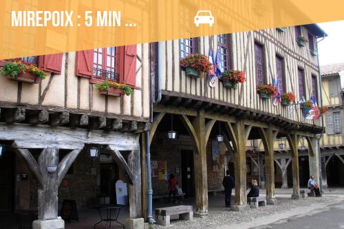 a group of buildings with flower boxes on them at Domaine La Belle Histoire - Gîte côté jardin in Besset