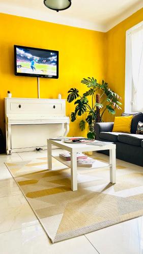 a living room with a white coffee table and a tv at ZAPPI CYCLING HOTEL in Riolo Terme
