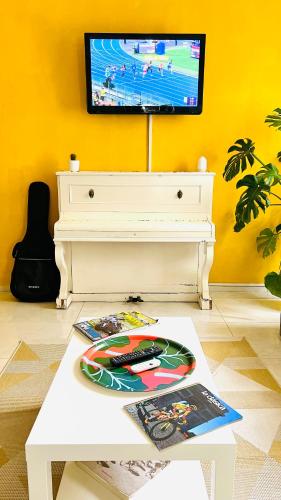 a living room with a white coffee table and a tv at ZAPPI CYCLING HOTEL in Riolo Terme